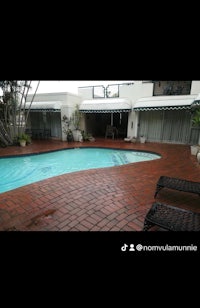 a swimming pool in front of a house